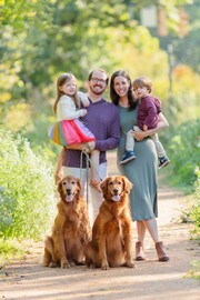 A happy family taken pictures with plenty of greenery, pathways, and backdrops